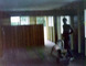 on back- looking from front of hall to back, an attempted picture of the inside of the house - the guy is sanding the floor